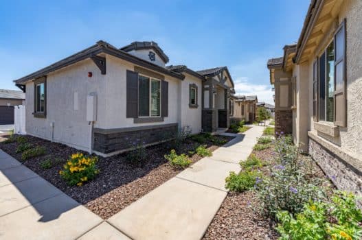 The exterior of the rental homes at our apartments in Peoria, AZ, featuring desert landscaping and stucco exteriors.